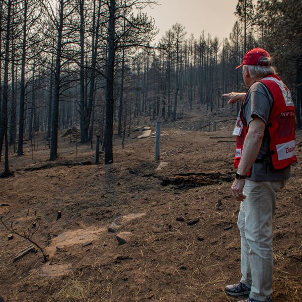 May 13, 2022. Rociada, New Mexico. Don has over 13 years of experience in disaster relief with the American Red Cross but he says that this wildfire is harder scene for him than managing flood or tornado relief. “ We’ve seen places with no identification left of their home. There are no signals up here so we’ve gone old school and rely on paper maps. It’s like detective work. It’s much harder”. Photo by Marko Kokic/American Red Cross