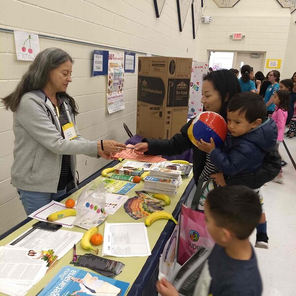 VSEP member at community health fair sharing benefits of a healthy vegan diet