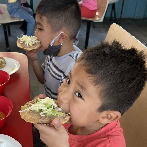 Boys eating tostadas