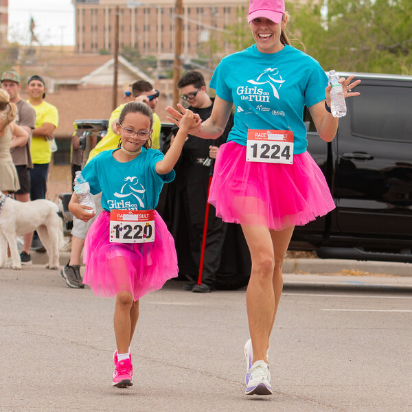 A GOTR El Paso coach and participant proudly race across the finish line at our end-of-season celebratory 5K, proving that there's no limit to what girls can achieve!
