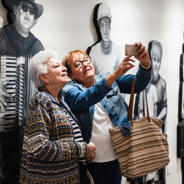 Amigas at the Es Hora Grand Opening - In front of work by Gaspar Enriquez