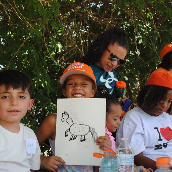Girl from the YWCA poses next to her horse drawing.