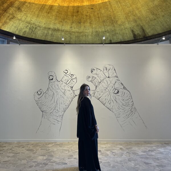 Mabel in front of the Hands Mural in Museo de Arte de Ciudad Juárez